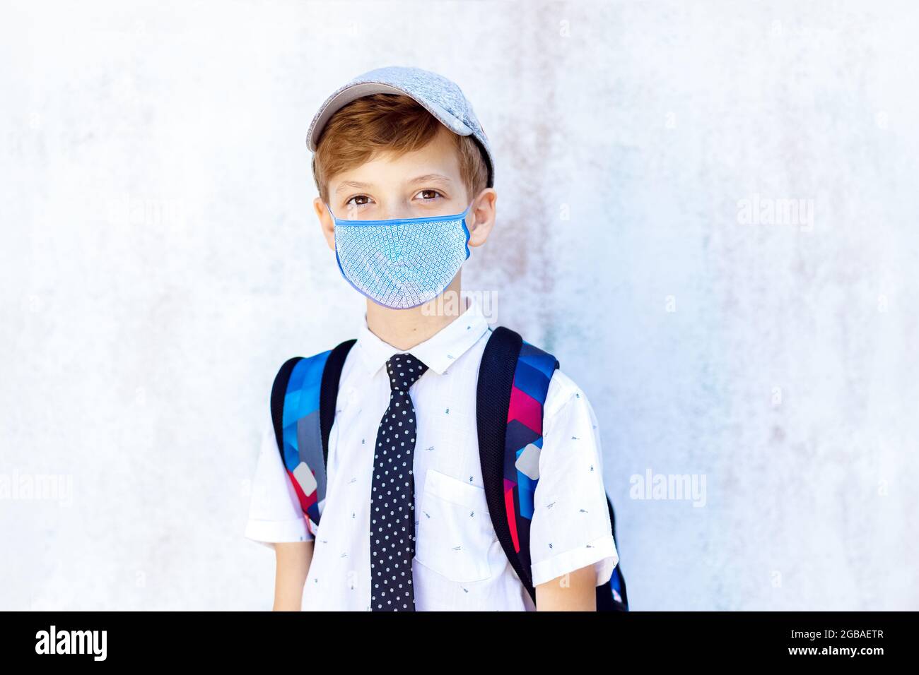 Portrait of happy student wearing face mask going back to school Stock Photo