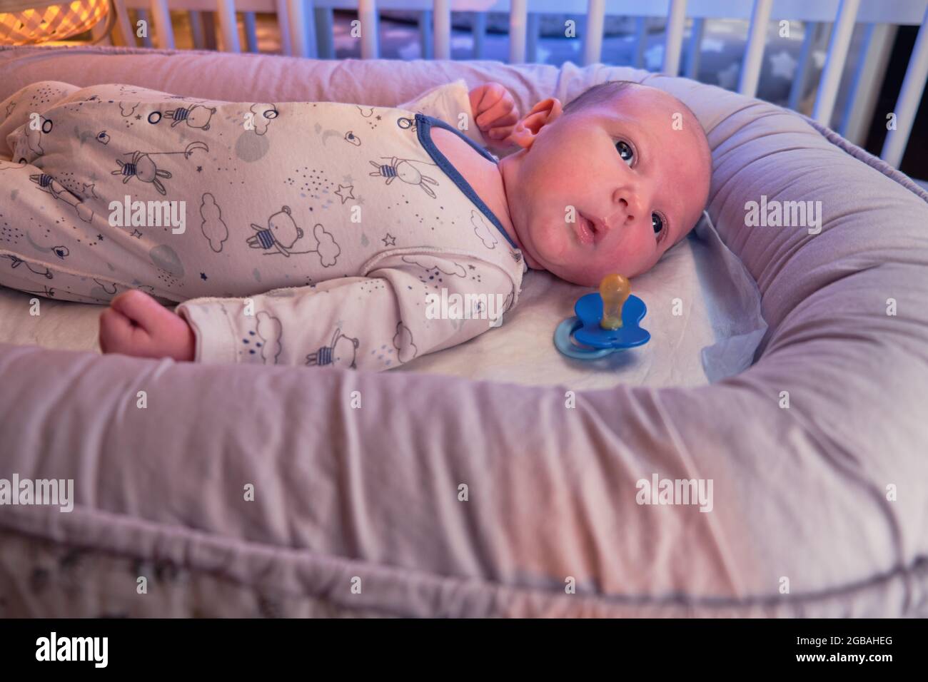 Portrait Of A Baby Boy Aged 1 Month Lying With His Eyes Open In A Crib Caucasian Child In The Children Bedroom On The Bed Stock Photo Alamy