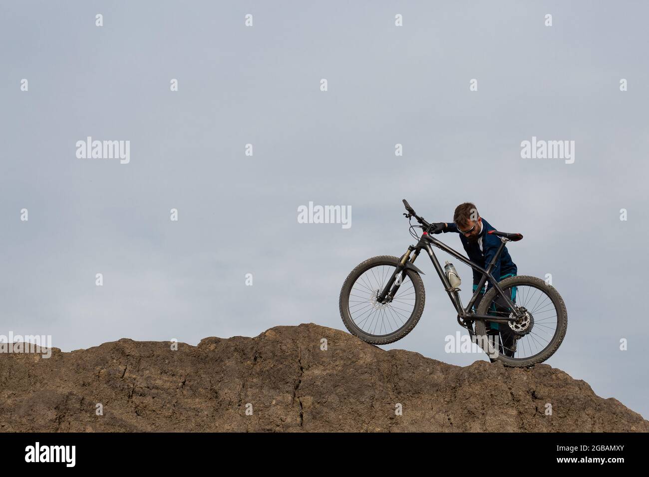 Bearded mountain bicyclist rides mountains Stock Photo - Alamy