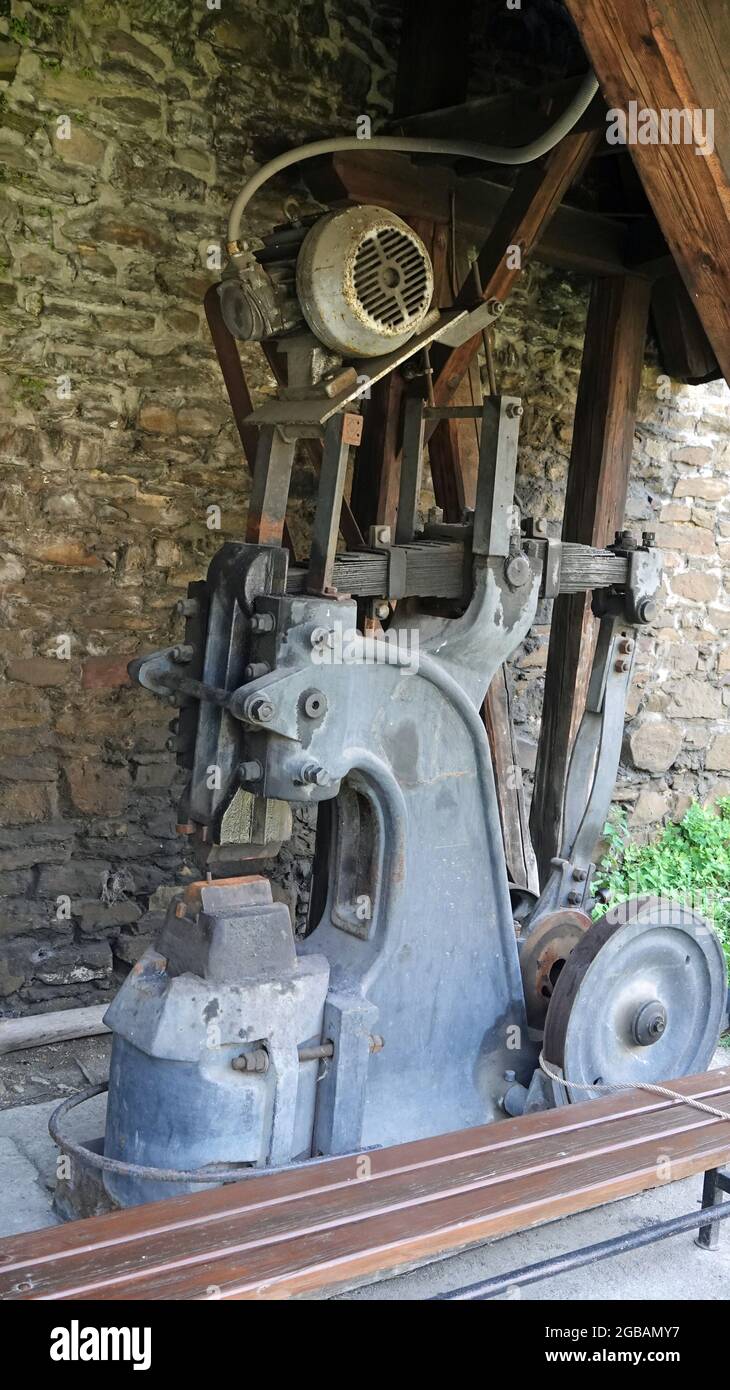 Old blacksmith motor hammer machine outdoor. Metal industry. Stock Photo