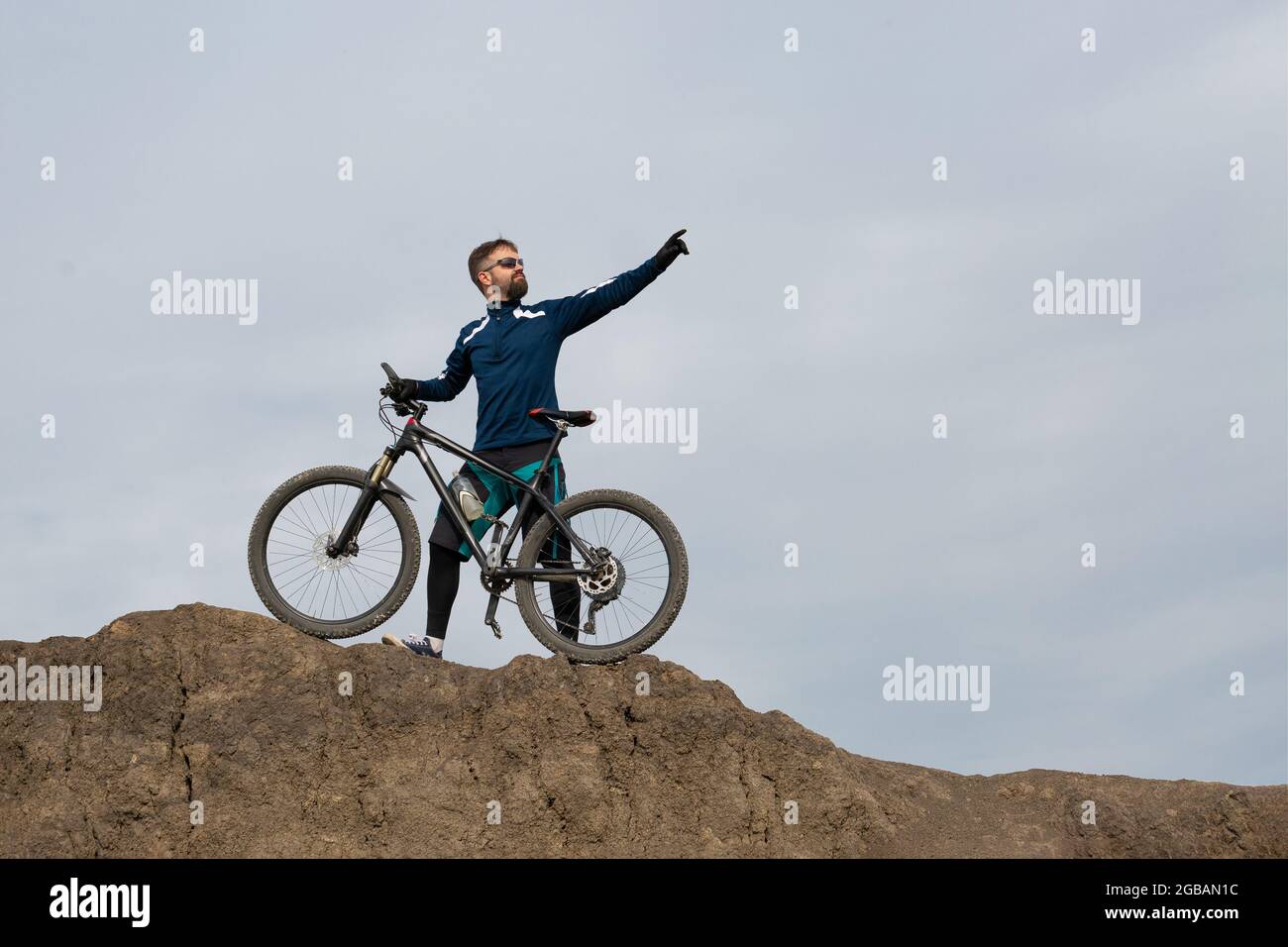 Bearded mountain bicyclist rides mountains Stock Photo - Alamy