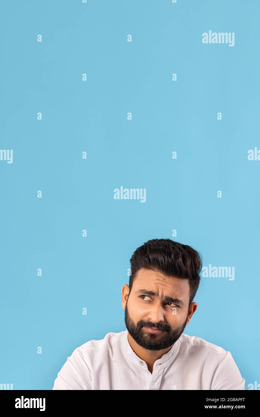 Young indian man thinking looking hi-res stock photography and images ...