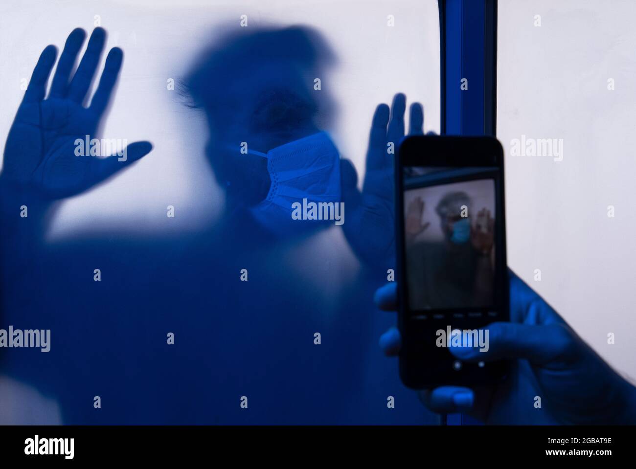 A young man quarantined in isolation during the pandemic being clicked in phone. Stock Photo
