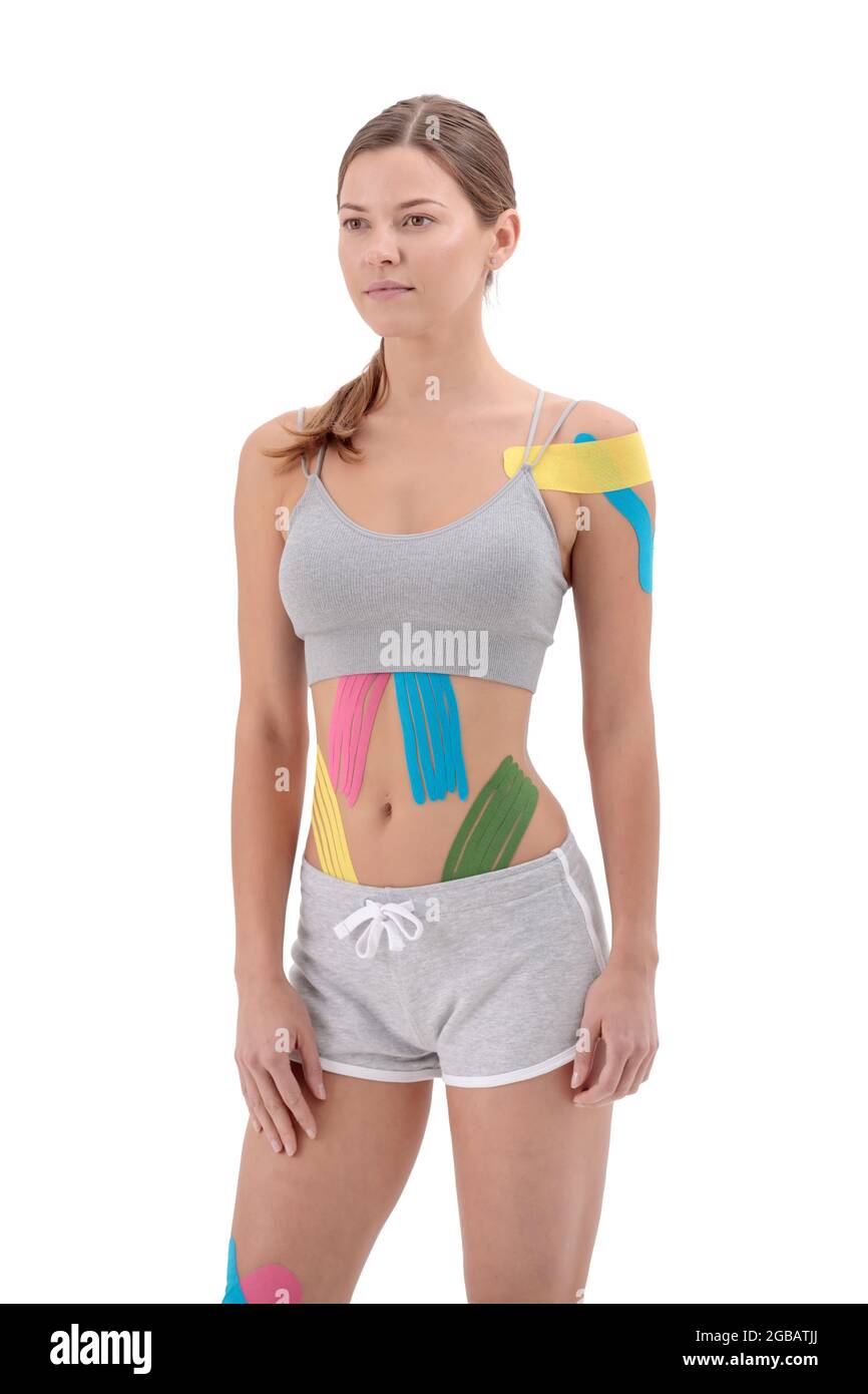 Woman showing kinesio tapes taped to her body. Full-length portrait of woman with Bright medical kinesio tapes Stock Photo