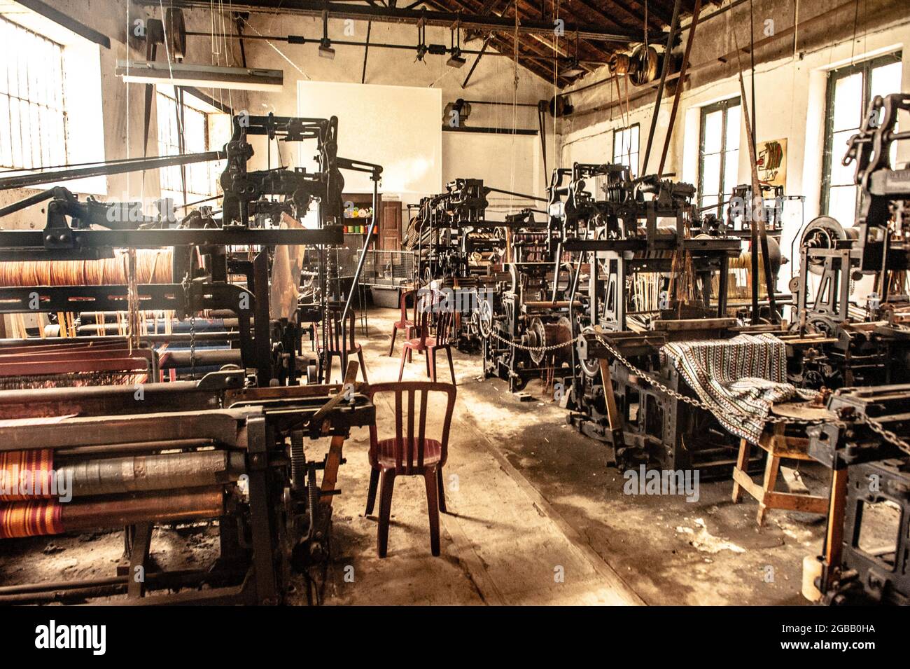 The former textile works of Arles-sur-Tech today house artist studios next to the historic machine hall, Le Moulin, Pyrénées-Orientales, France Stock Photo