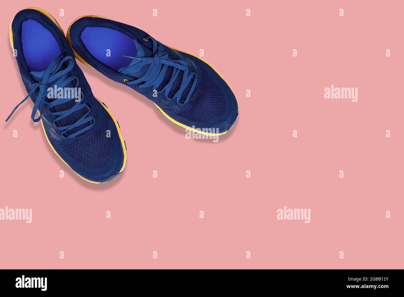 blue sneakers on a  pink background Stock Photo
