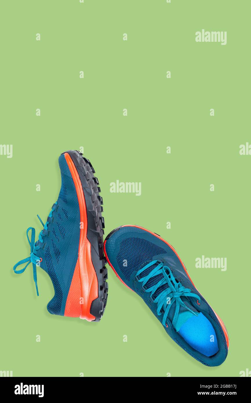 blue sneakers on a green background Stock Photo - Alamy