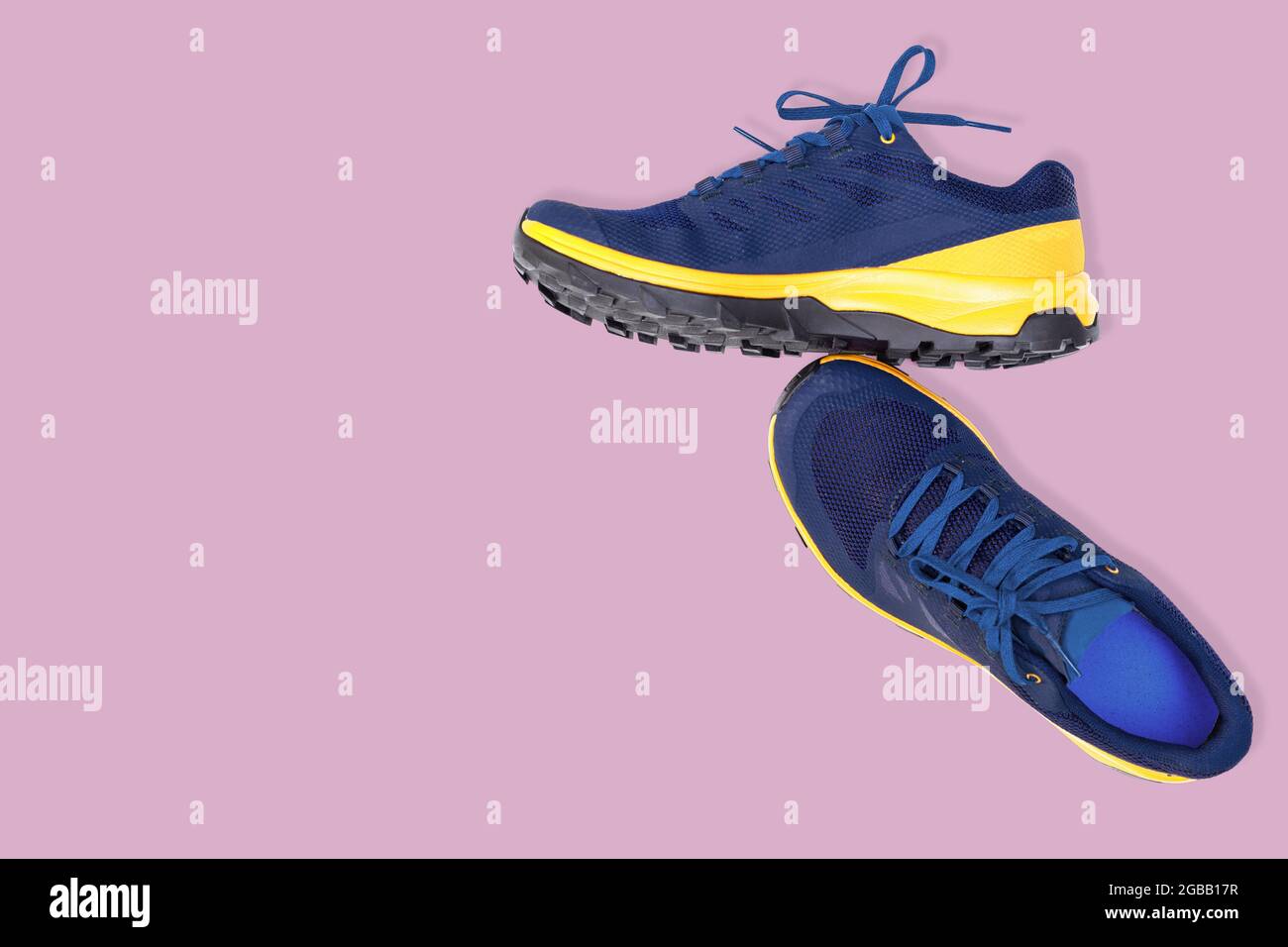 blue sneakers on a pink background Stock Photo - Alamy