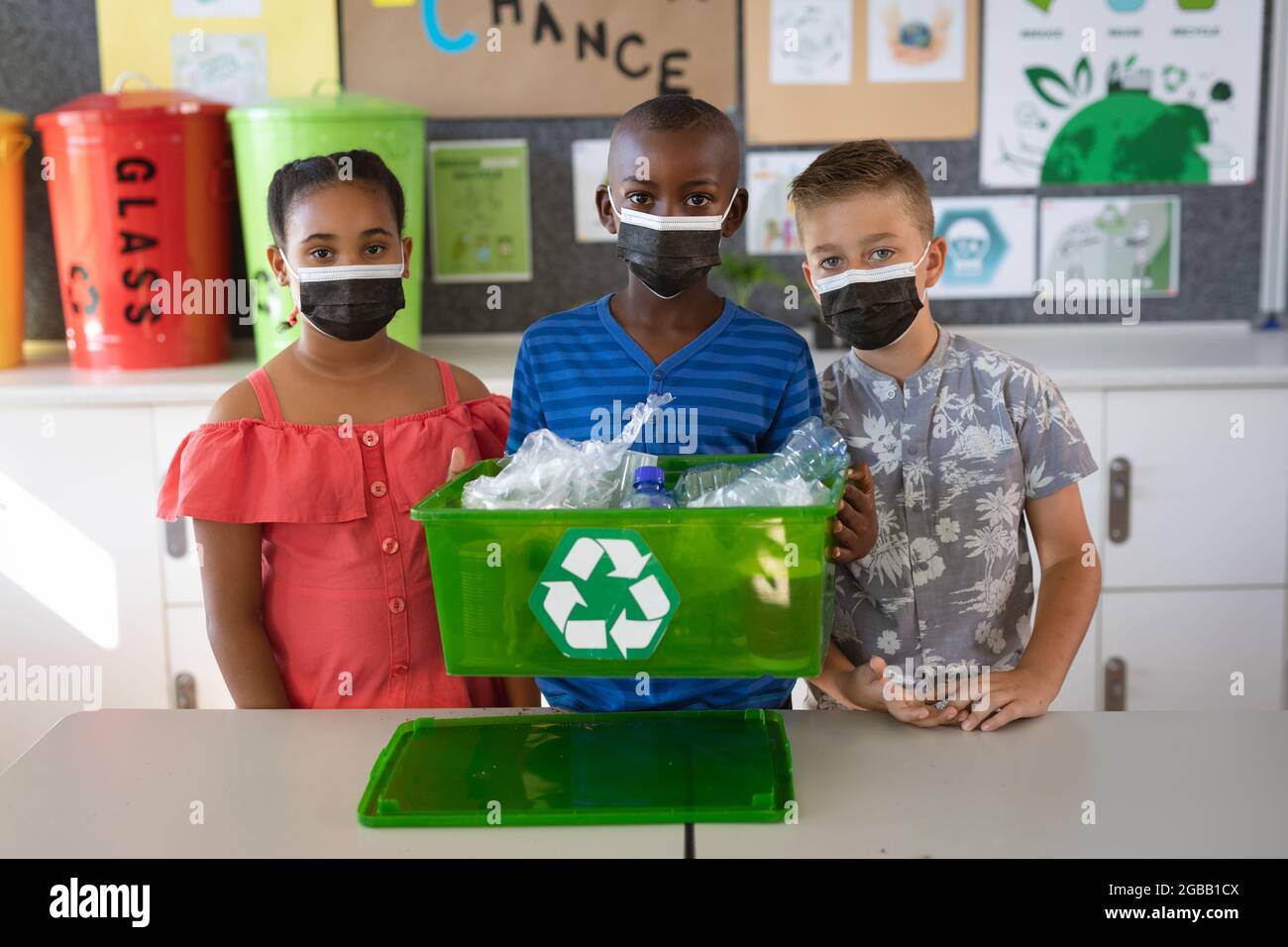Group of diverse students wearing face masks holding a tray filled with