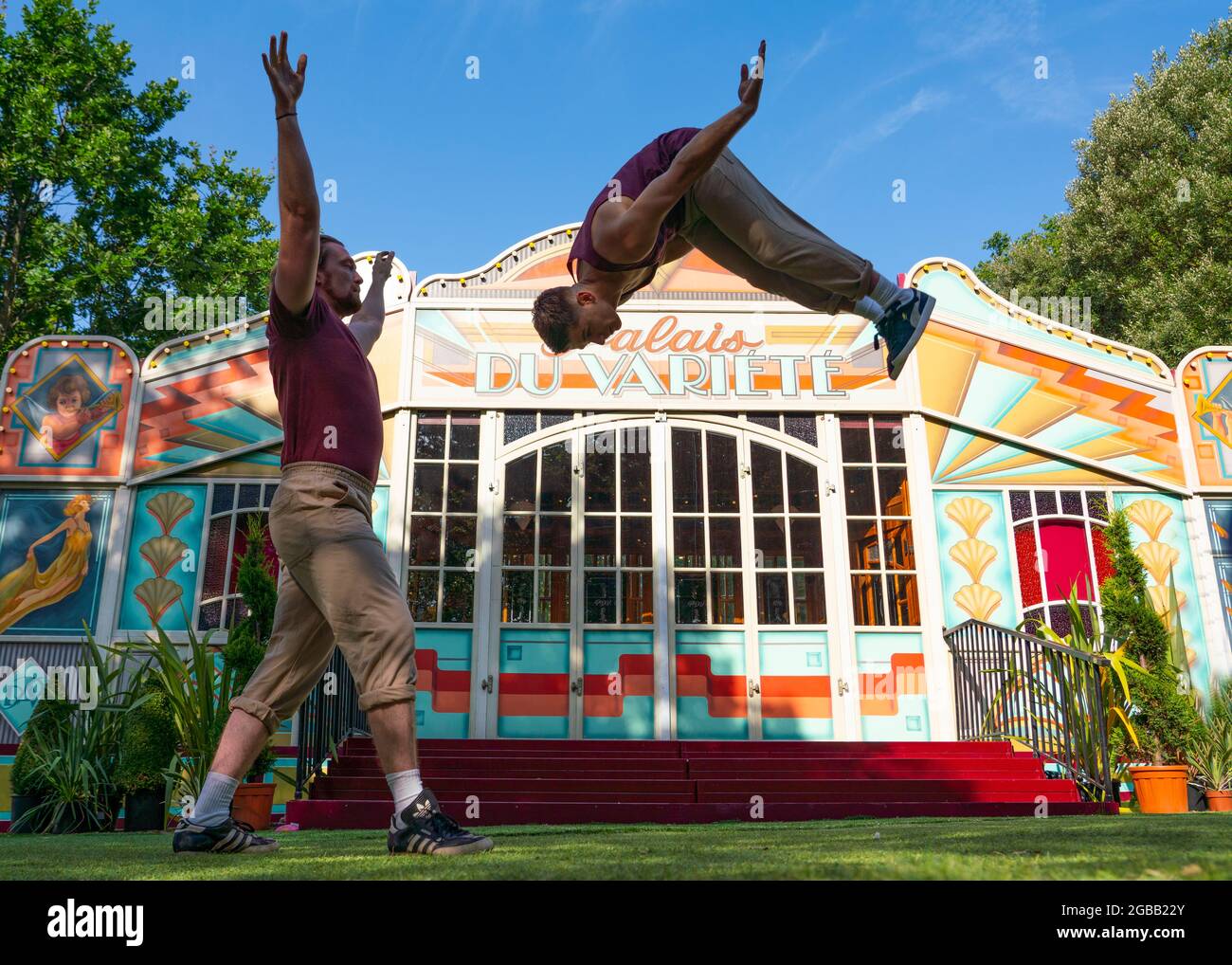 Edinburgh, Scotland, UK. 3 August  2021.  Performers from the experimental acrobatic circus company Barely Methodical Troupe perform outside the Palais du Variété Spiegeltent in George Square Gardens to kick off the Assembly Festival’s summer Fringe programme. The Troupe are performing their cutting edge show Bromance that wittily explores male companionship and its limits. Iain Masterton/Alamy Live news. Stock Photo