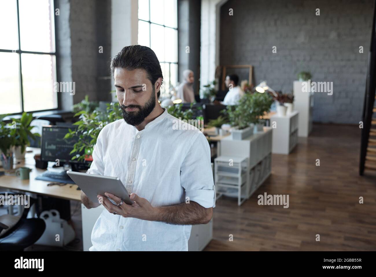 Adult businessman scrolling through tablet hi-res stock photography and ...