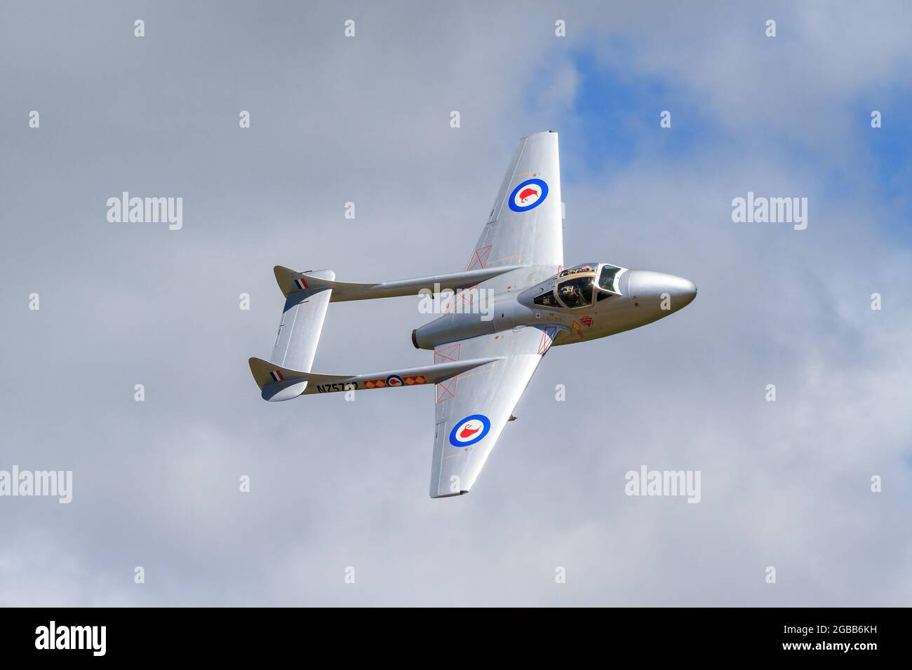 A De Havilland DH115 Vampire, a 1940s British jet fighter, in the sky at an airshow. It is painted in New Zealand Air Force colors Stock Photo