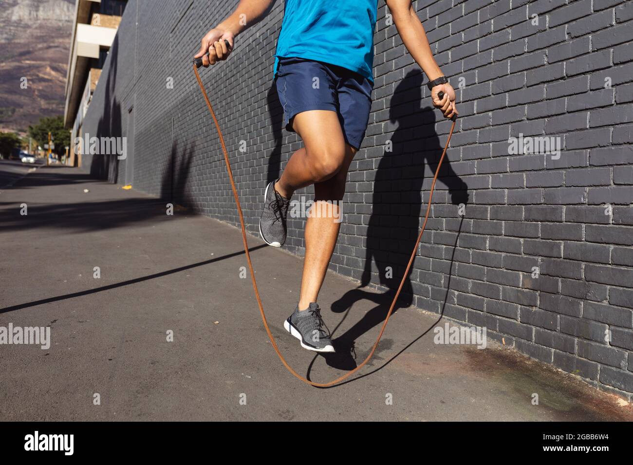 Unrecognizable Sportswoman Jumping Rope On A Bridge Stock Photo