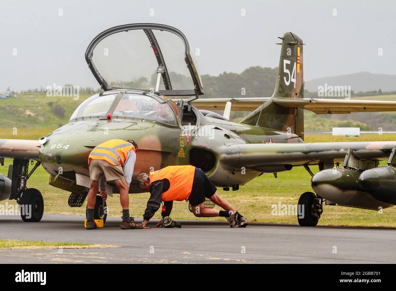 A BAS Strikemaster Mk 88, a British attack aircraft, being examined by ground crew. Photographed at an airshow in New Zealand Stock Photo
