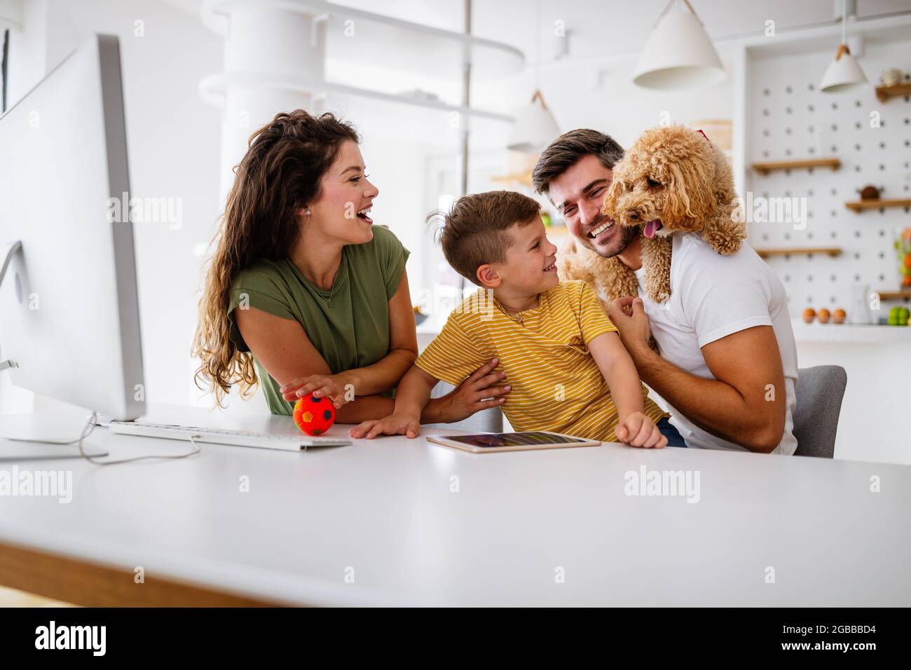 Happy modern family using computer together at home Stock Photo - Alamy