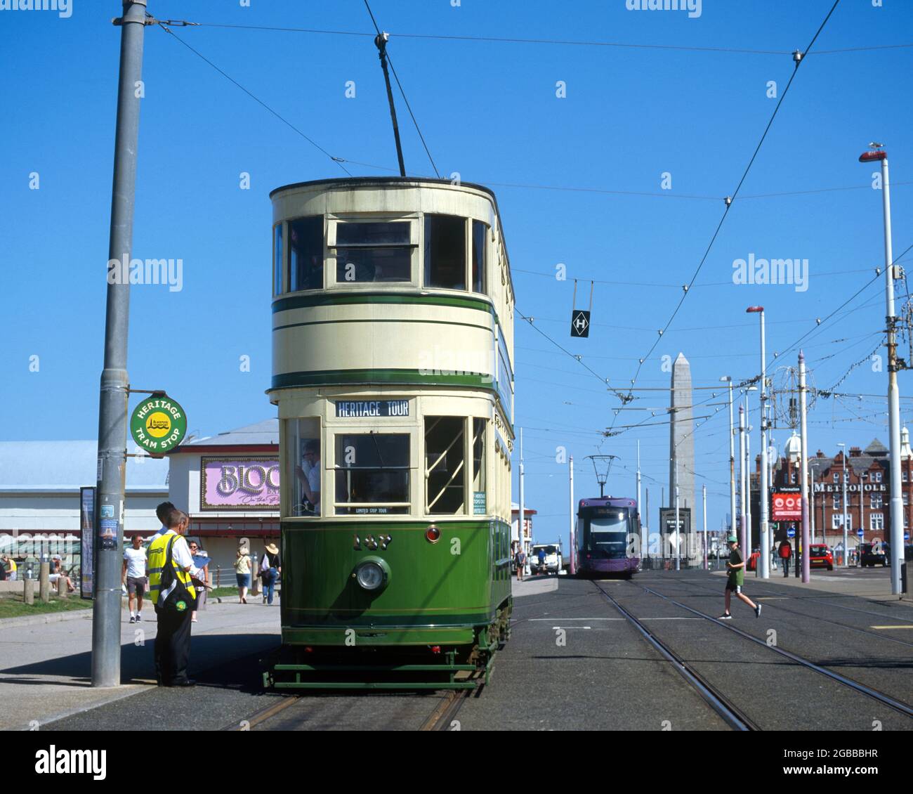 Blackpool, UK - 17 July 2021: A heritage double decker tram at the seafront and a modern tram in the rear. Stock Photo