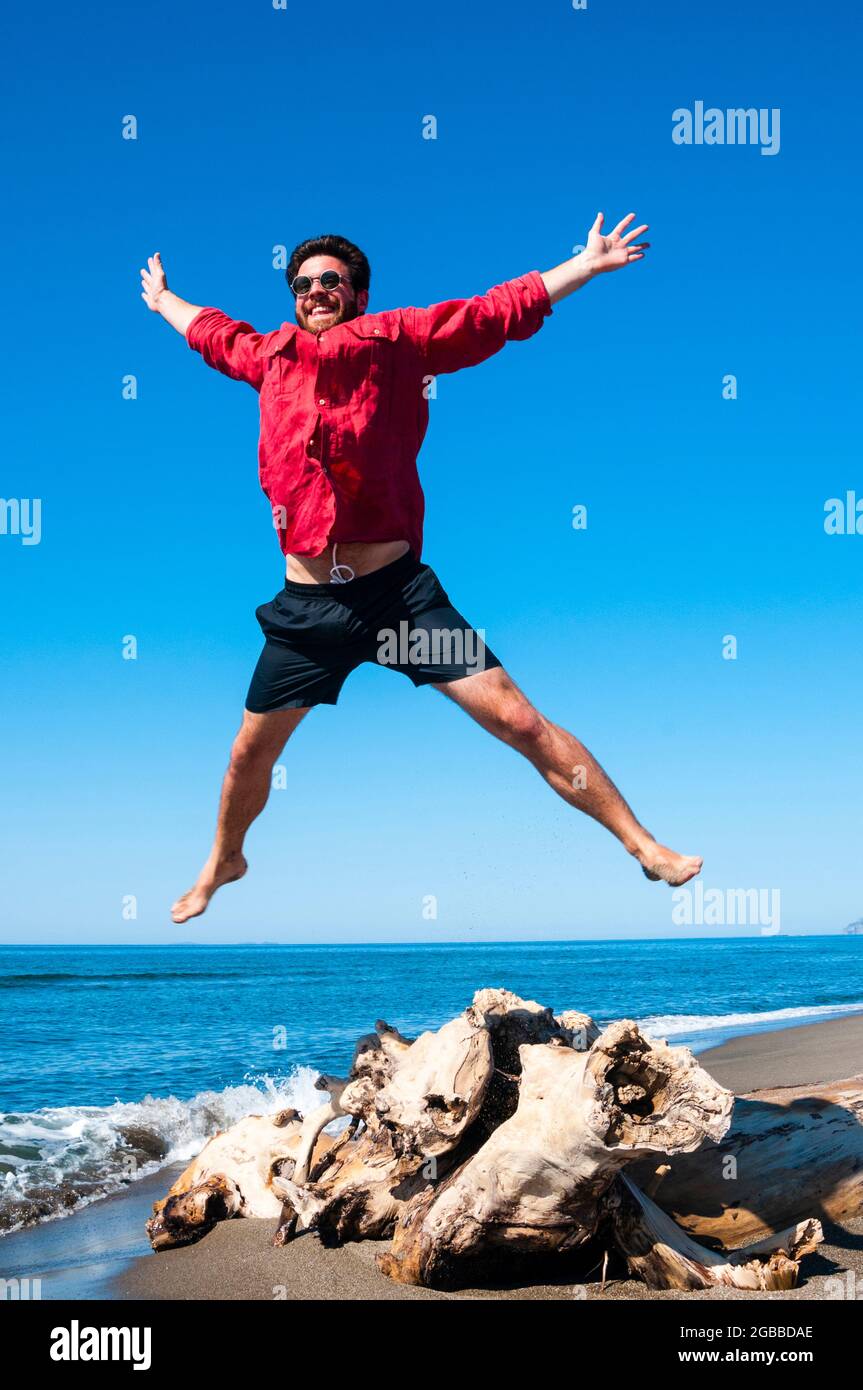 Jumping close to sea, Capalbio beach, province of Grosseto, Tuscany, Italy, Europe Stock Photo