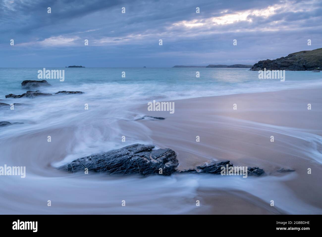 Waves wash over Mother Ivey's Beach at dawn, St. Merryn, Cornwall, England, United Kingdom, Europe Stock Photo