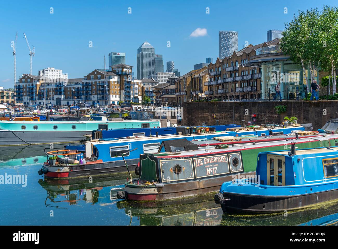 View of canal boats in the marina at the Limehouse Basin and Canary Wharf in background, Limehouse, London, England, United Kingdom, Europe Stock Photo