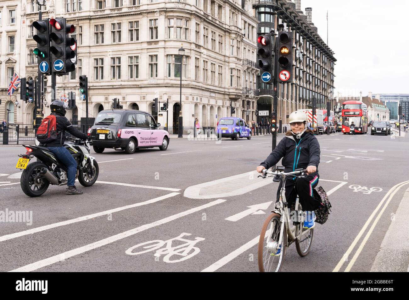 cycle to work, woman cyclist riding bike in cycle lane Stock Photo