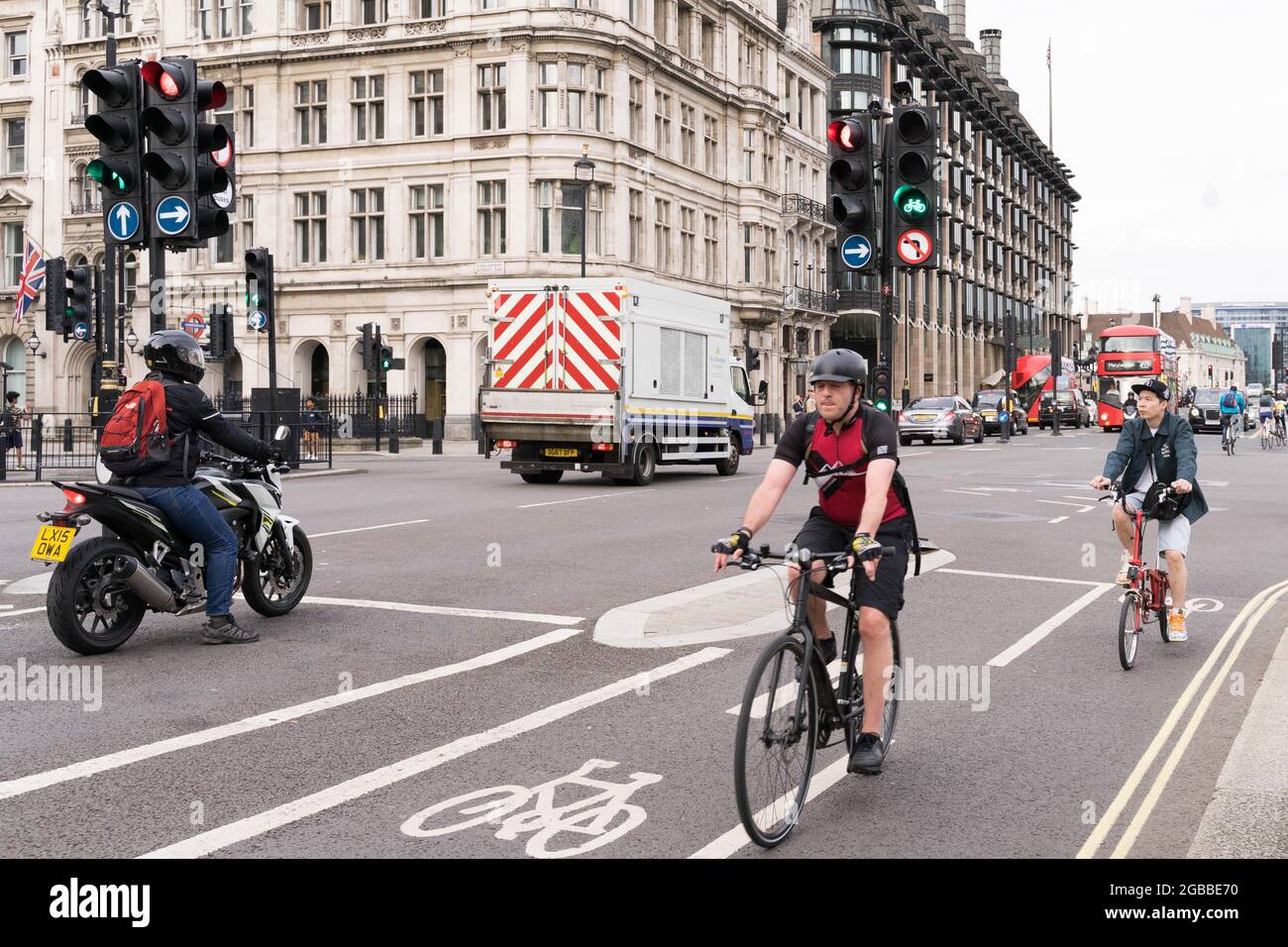 cyclist on cycle lane during evening traffic co -exists with car traffic City of Westminster London England UK Stock Photo