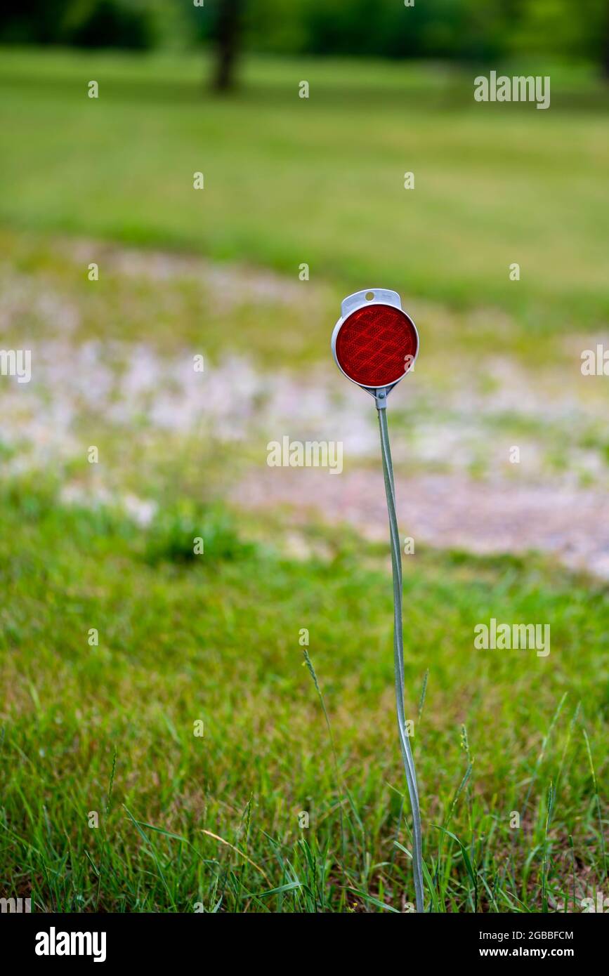 Reflector on metal post marking the entry to a private driveway Stock