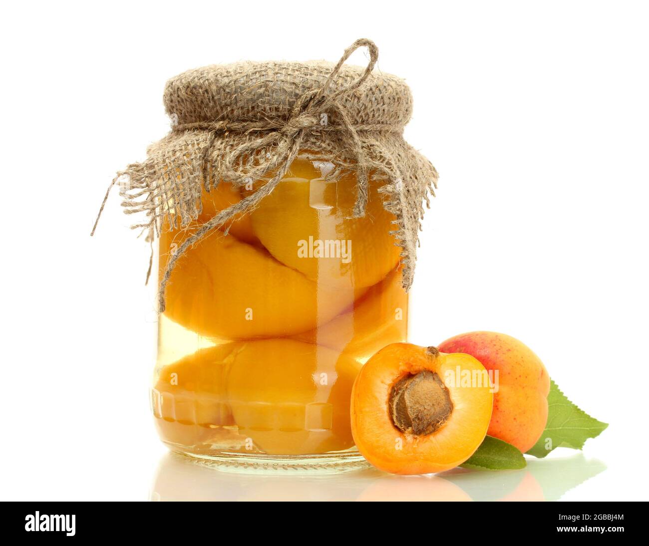 canned apricots in a jar and sweet apricots isolated on white Stock