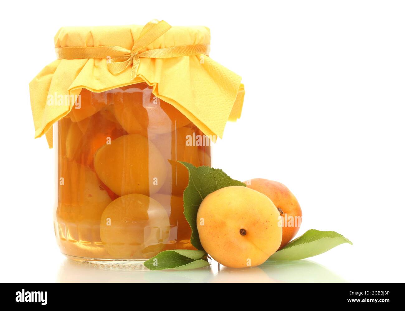 canned apricots in a jar and sweet apricots isolated on white Stock