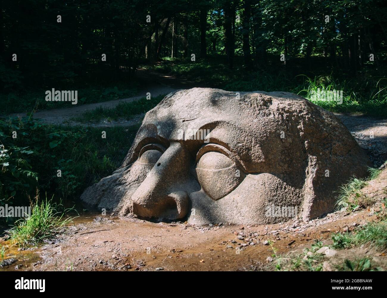 The 'Head' is a sculpture made of granite stone by an unknown master. Stock Photo