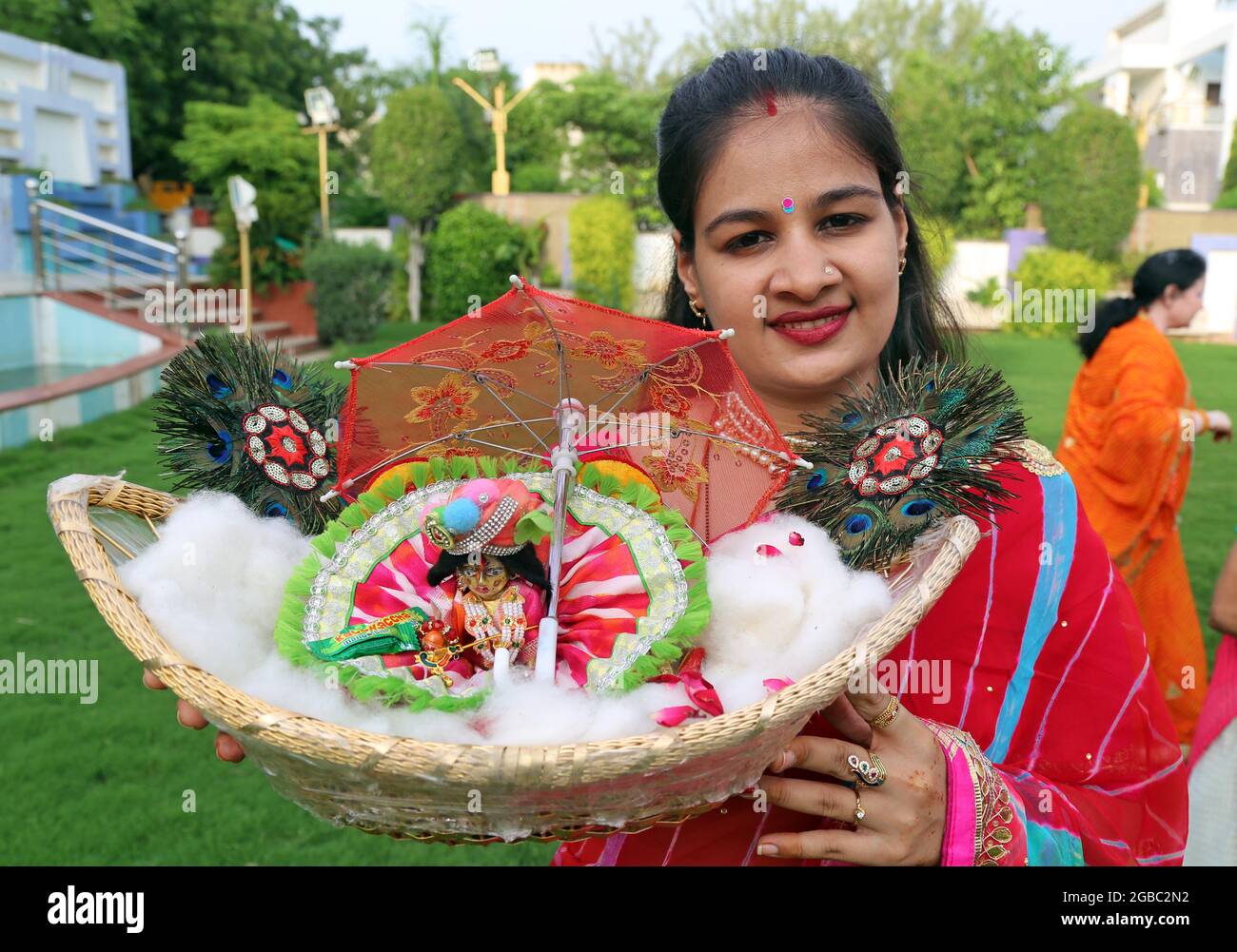 Beawar, Rajasthan, India, August 2, 2021: Hindu woman with the idol of Laddu Gopal (Lord Krishna), pose for a picture as she celebrate the holy month of Sawan (Shravan) in Beawar. Photo: Sumit Saraswat Stock Photo