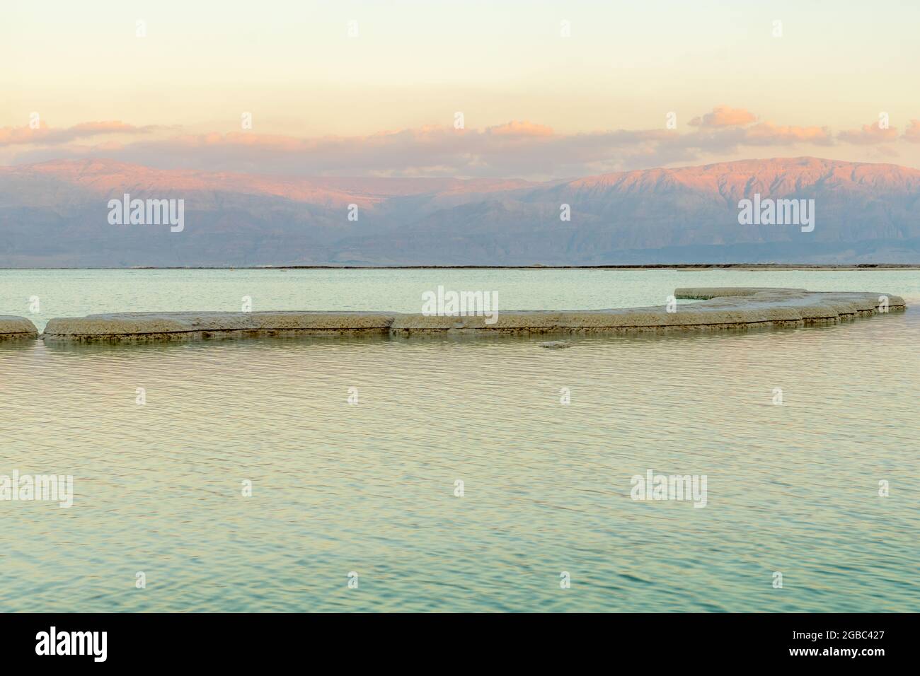 Sunset view of salt formations in the Dead Sea, with the Edom Mountains in the background. Southern Israel Stock Photo