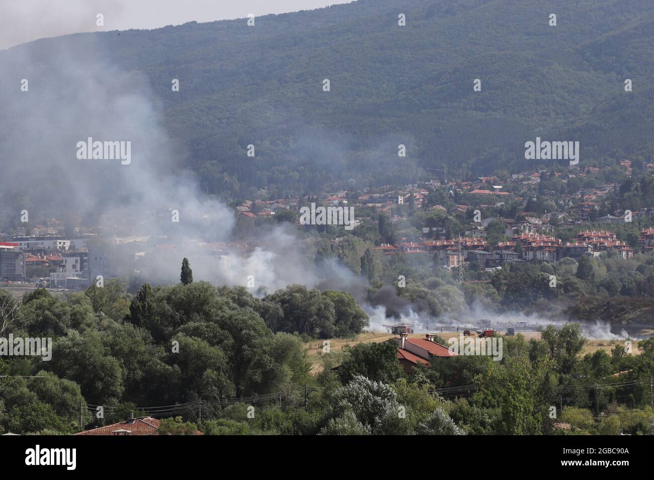 A large fire is burning from burning stubble in Sofia, Bulgaria on August, 3, 2021. The fire is burning the forest, field, houses above living areas M Stock Photo