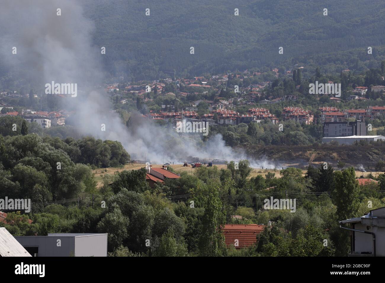 A large fire is burning from burning stubble in Sofia, Bulgaria on August, 3, 2021. The fire is burning the forest, field, houses above living areas M Stock Photo
