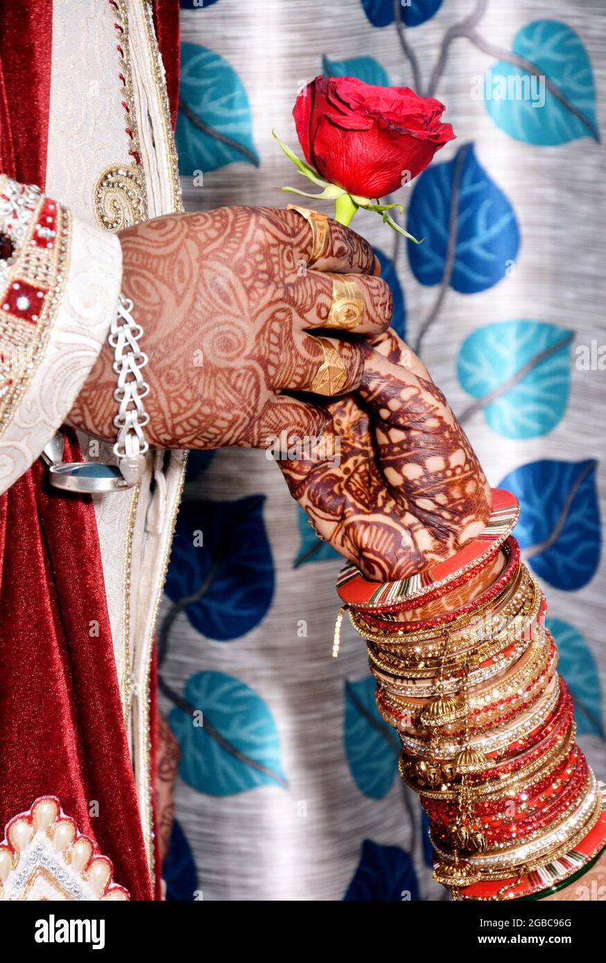 A closeup of an Indian groom giving a rose flower to a bride during wedding  ceremony Stock Photo - Alamy