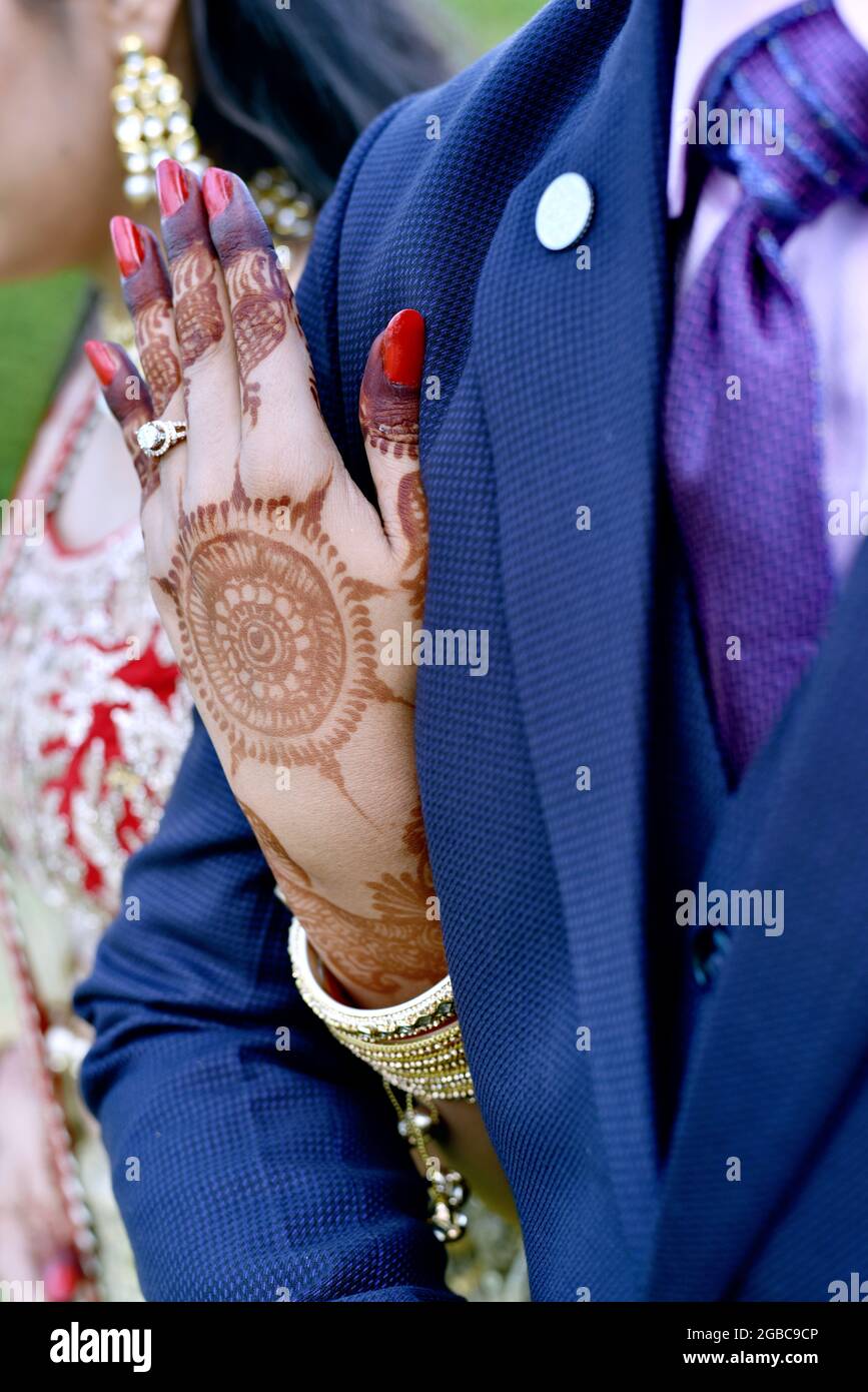 A closup shot of a young couple hugging and showing their wedding rings in india Stock Photo