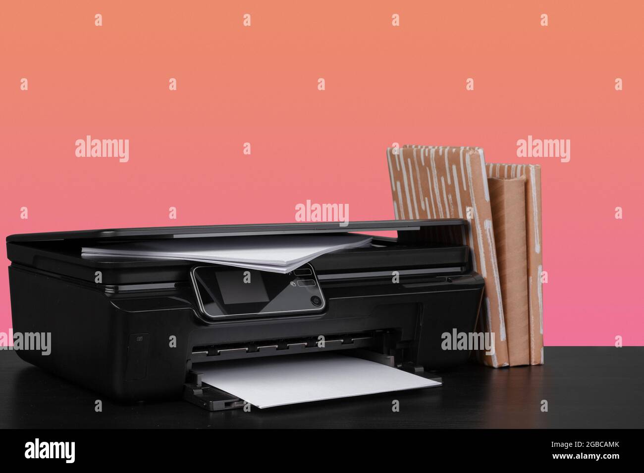 Compact home laser printer against orange background Stock Photo