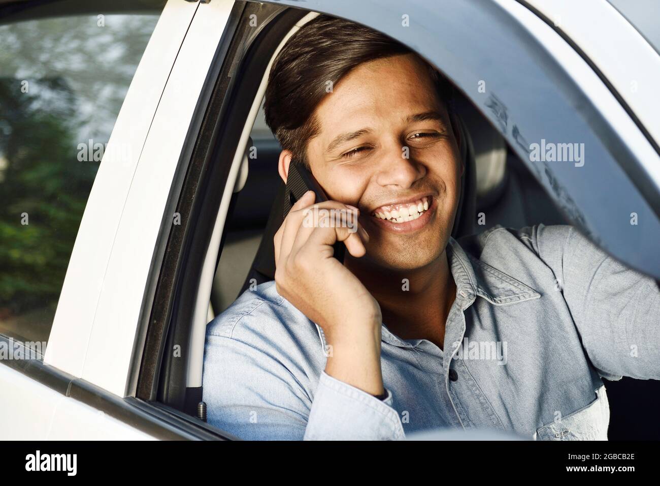 Indian Cab driver Taking On Phone While Driving Stock Photo