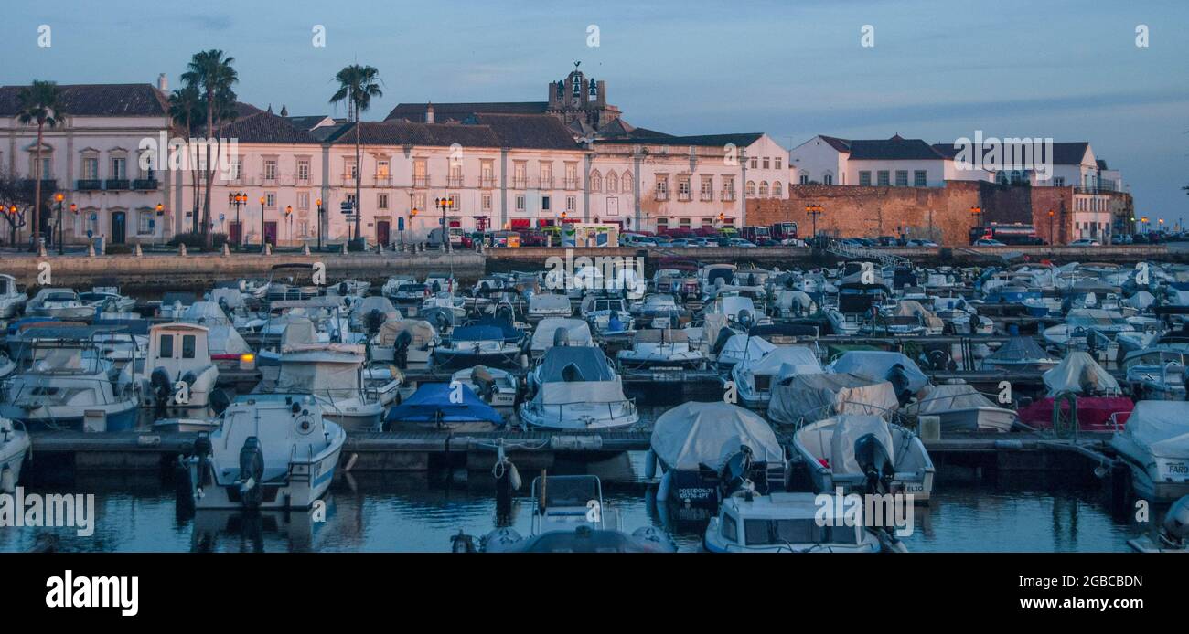 Faro port at sunset, pink-lit buildings and sleepy boats in the harbor -  Portugal, Panorama Stock Photo - Alamy