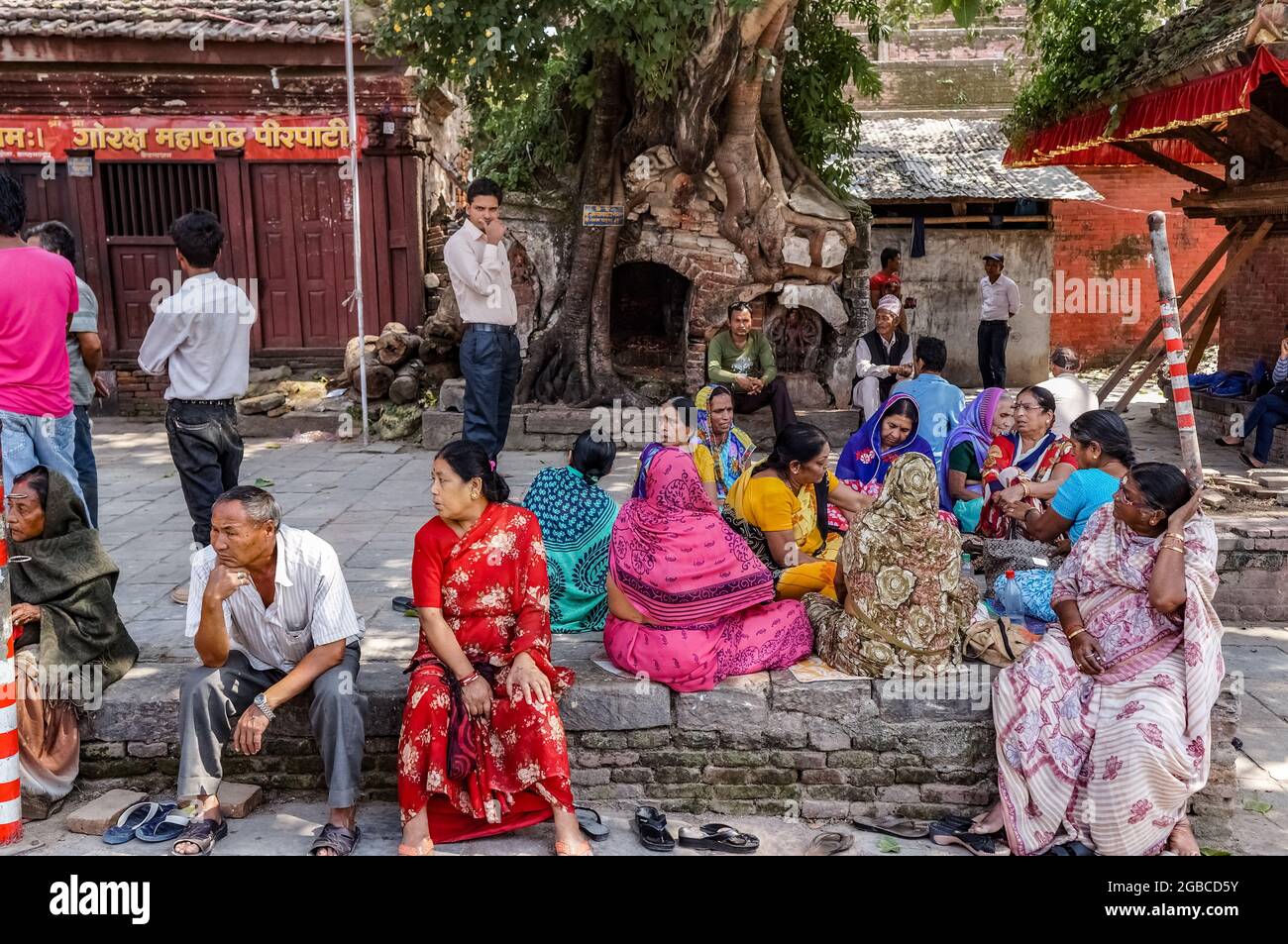 Nepalese women sitting wearing traditional clothing in Hanuman Dhoka, Kathmandu Durbar Square Stock Photo