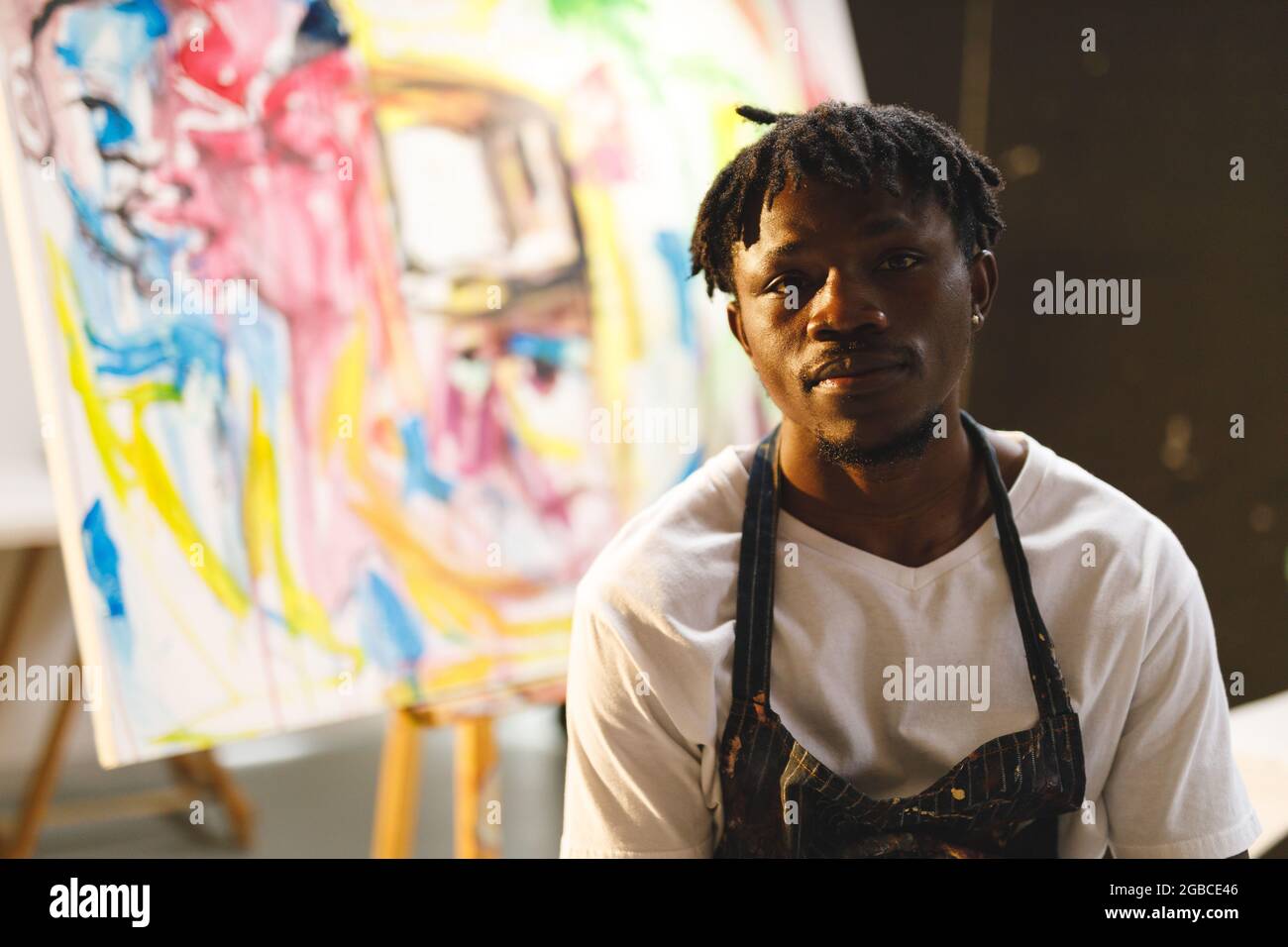 Portrait of african american male painter at work looking at camera in art studio Stock Photo