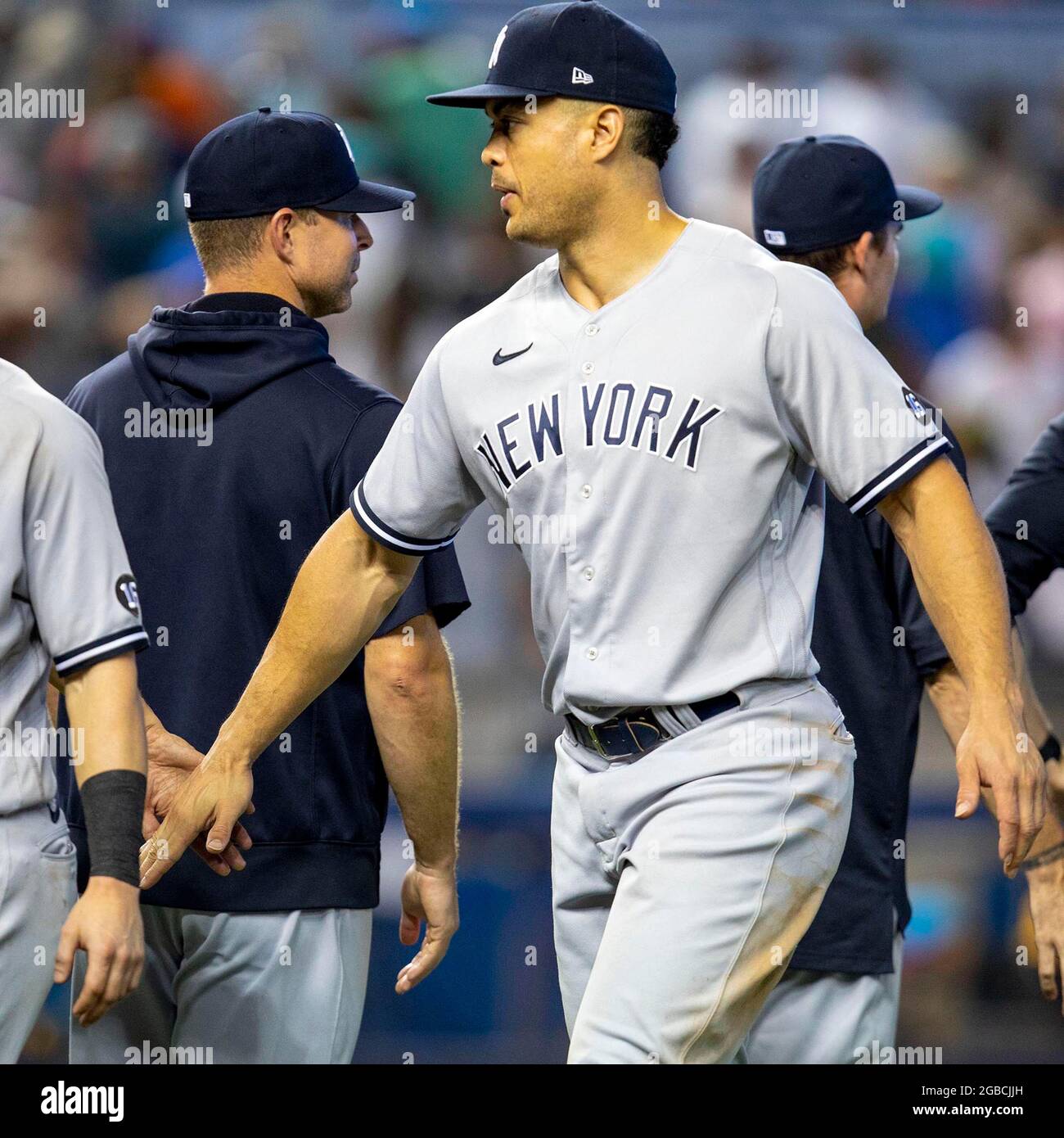 New York Yankees player Giancarlo Stanton (27) reacts with his teammtes  after the ninth inning against the Miami Marlins at loanDepot park in the  Little Havana neighborhood of Miami, Florida, on Sunday
