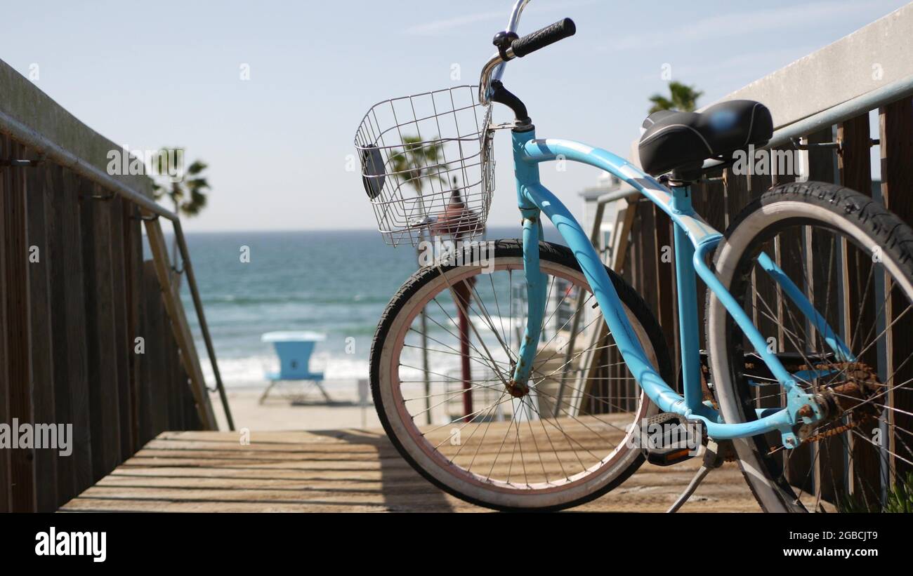 Blue bicycle cruiser bike by ocean beach pacific coast