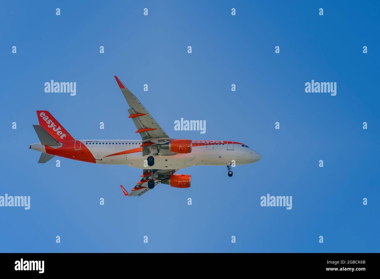 An easyjet switzerland airbus A320-200 registration HB-JXL in mid air coming in to land at Faro airport. passenger jet plane flying Stock Photo