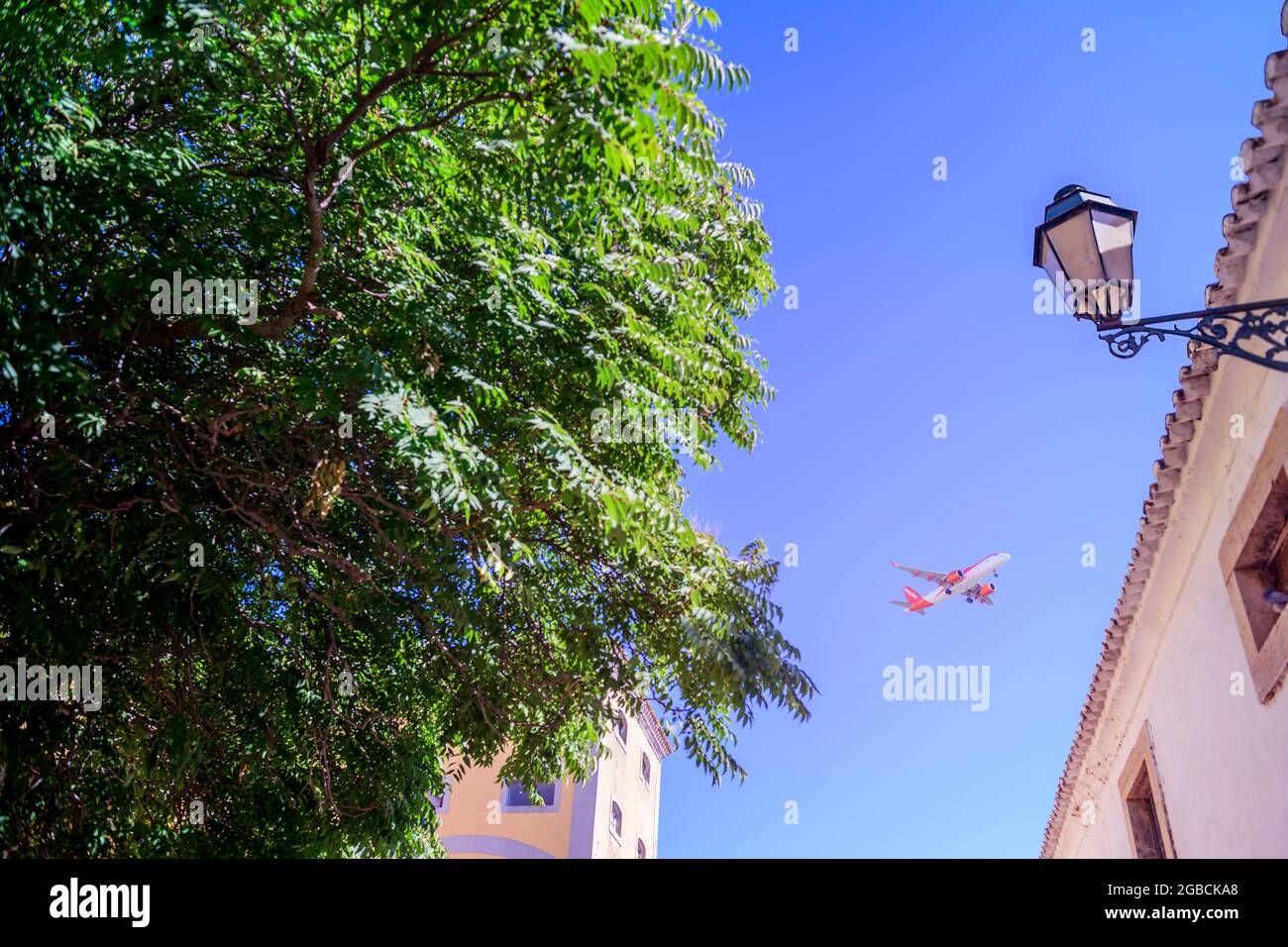 An easyjet airbus A320 flies overhead coming into land at Faro airport. Faro Algarve Portugal Stock Photo