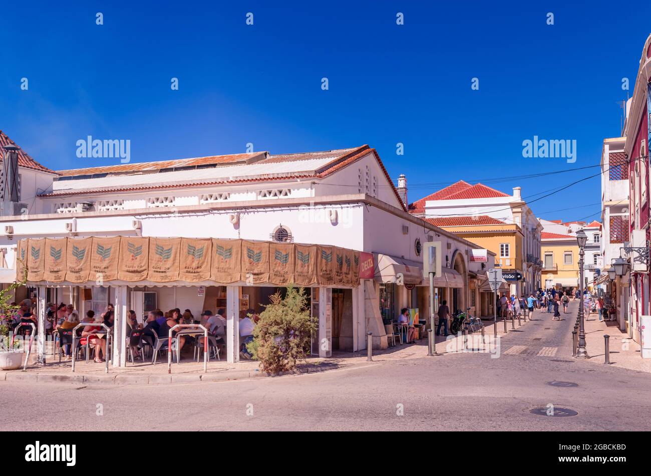 People eating and drinking in a street restaurant at Silves Algarve Portugal Stock Photo