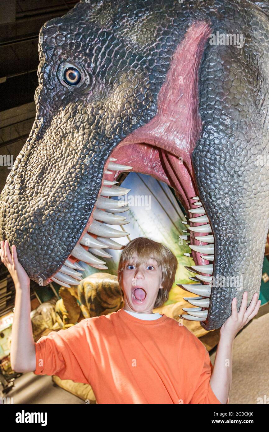 Birmingham Alabama,McWane Center centre,Adventures in Science Tyrannosaurus rex dinosaur exhibit,boy jaws reacting screaming scared acting, Stock Photo