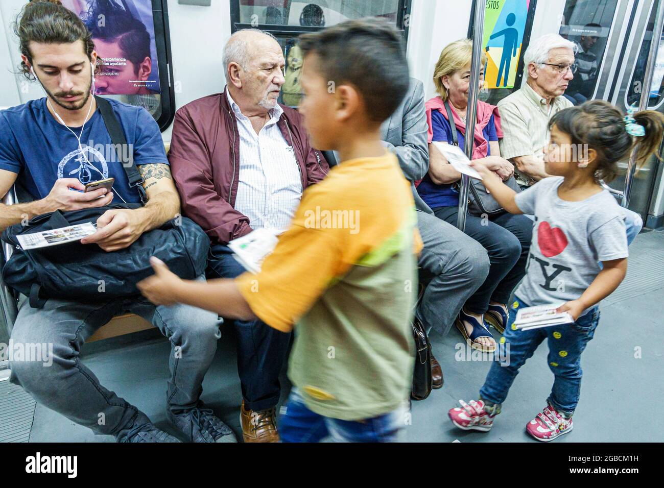 Argentina Buenos Aires,Subte subway public transportation moving train girl boy commuters,child labor selling begging cabin car interior inside passen Stock Photo