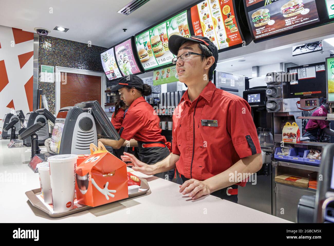 Sydney Australia,CBD Circular Quay,McDonald's restaurant fast food counter serving order tray,Asian man employee worker working, Stock Photo