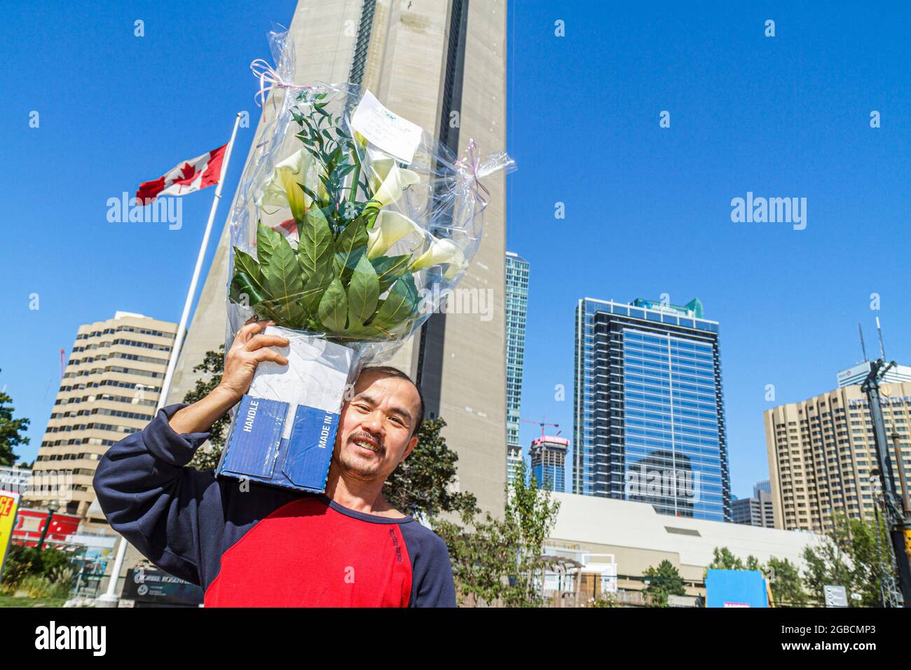 Toronto Canada,Bremner Boulevard CN Tower,observation skyline Canadian Asian man carrying flowers delivery delivering, Stock Photo