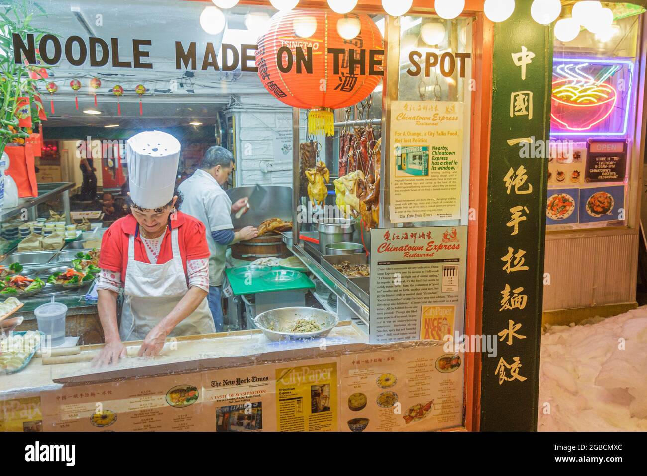 Washington DC,Chinatown 6th Street NW,Chinatown Express restaurant Chinese food,window making handmade noodles duck Asian woman, Stock Photo